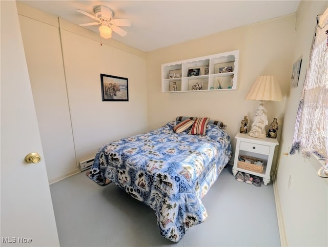 bedroom with a ceiling fan and baseboard heating