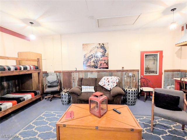 living area with attic access and concrete floors