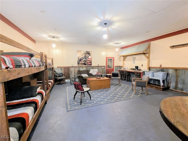 living room with finished concrete flooring and wainscoting