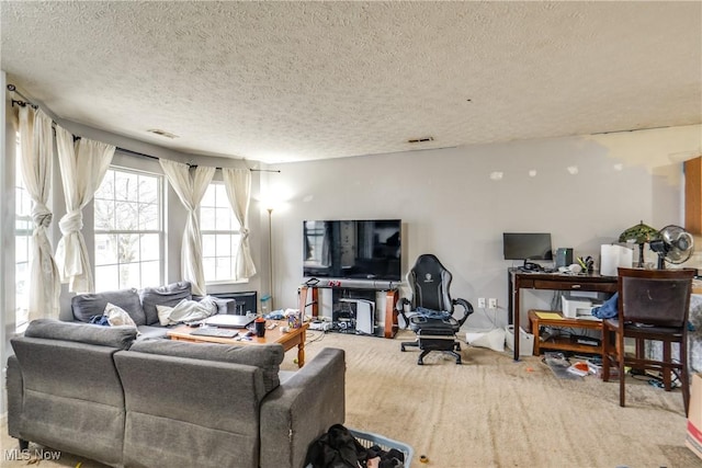 carpeted living area featuring visible vents and a textured ceiling