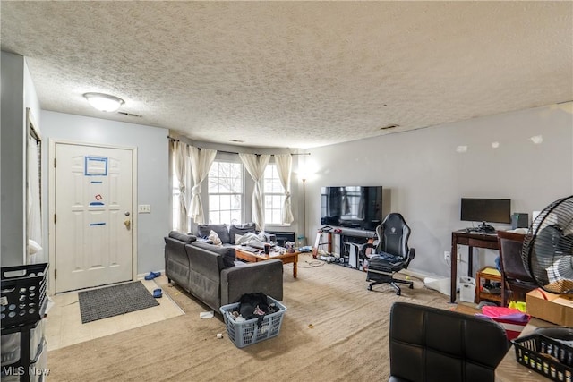 carpeted living room with visible vents and a textured ceiling