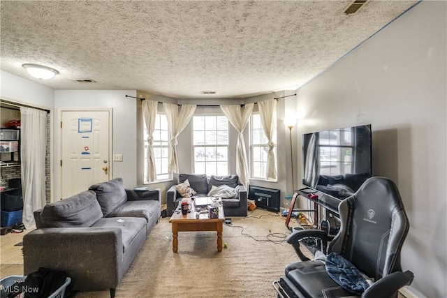 carpeted living area featuring visible vents and a textured ceiling