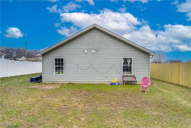 view of home's exterior with a yard and a fenced backyard