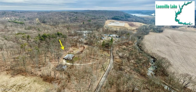 birds eye view of property with a forest view