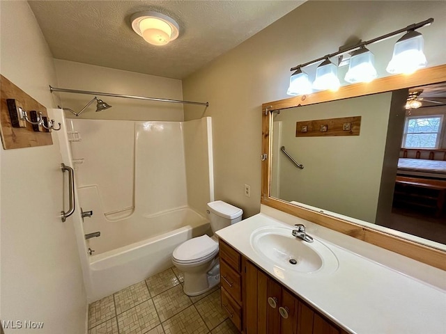 bathroom featuring toilet, a textured ceiling, vanity, and washtub / shower combination