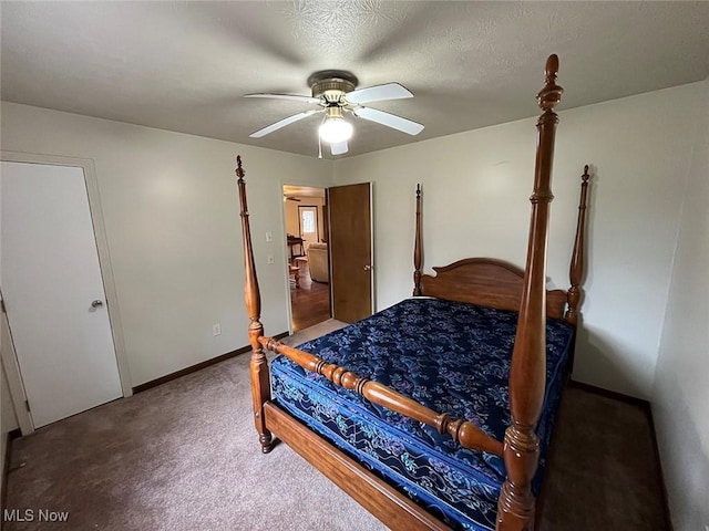 bedroom with carpet flooring, a textured ceiling, baseboards, and a ceiling fan