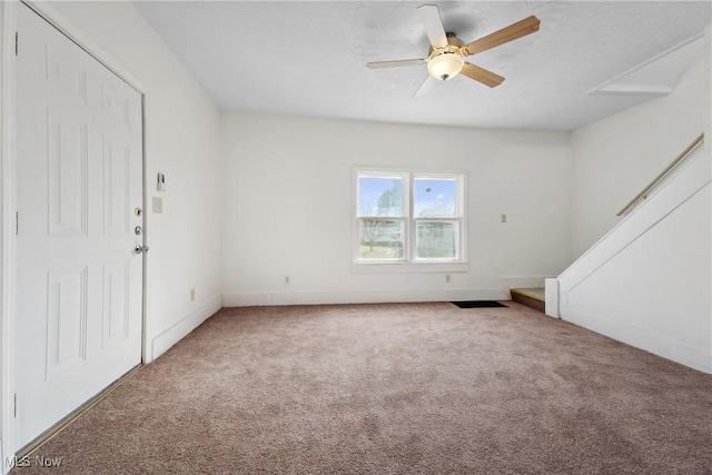 unfurnished living room featuring baseboards, a ceiling fan, and carpet flooring