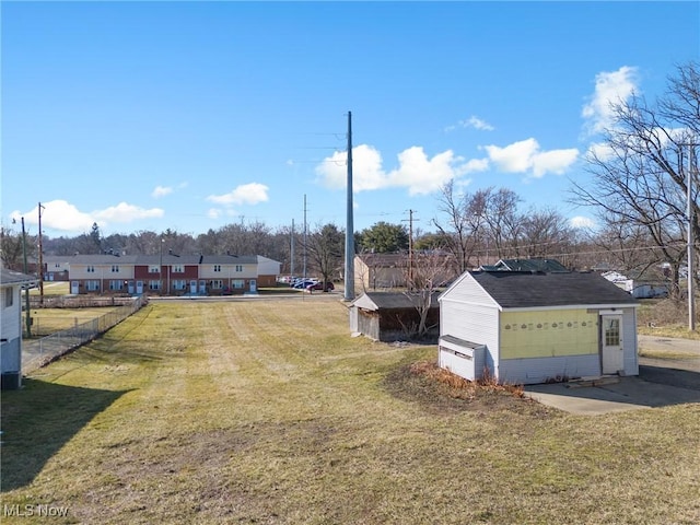 view of yard featuring an outdoor structure and fence