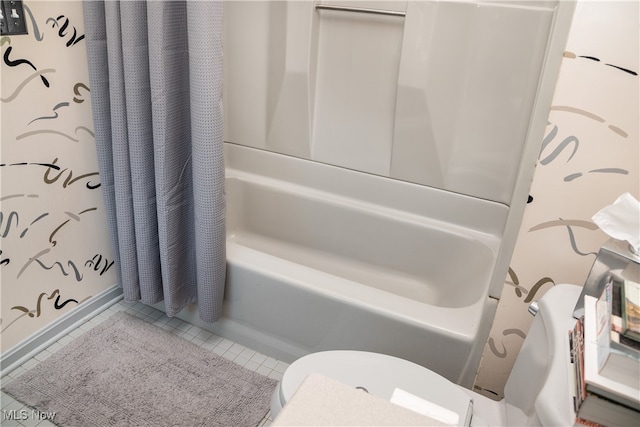 bathroom featuring tile patterned floors, toilet, and shower / tub combo