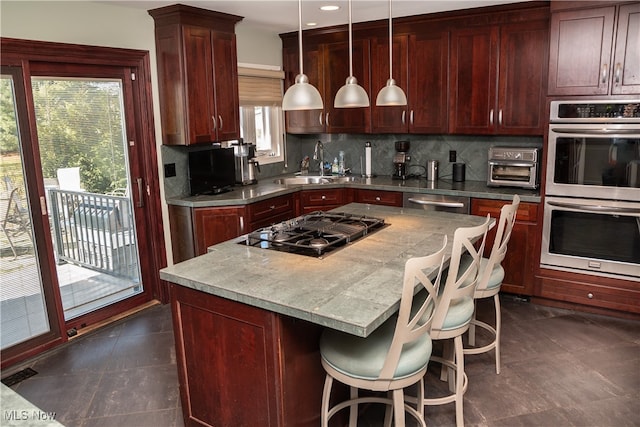 kitchen with a sink, decorative backsplash, black gas cooktop, dark brown cabinets, and double oven