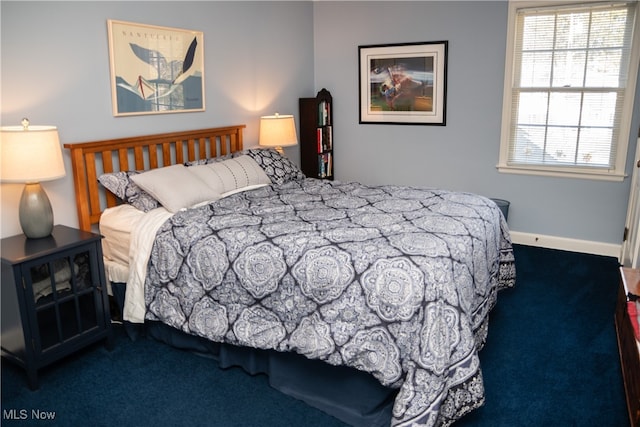 carpeted bedroom featuring baseboards