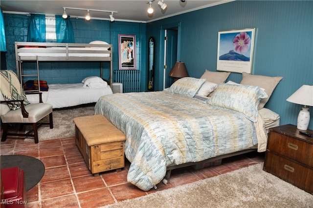 bedroom with tile patterned floors and crown molding