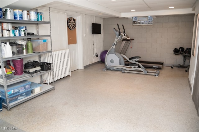 workout area with concrete block wall, recessed lighting, and a drop ceiling