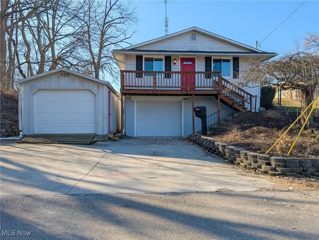 view of front of home featuring stairs, an outbuilding, covered porch, and driveway