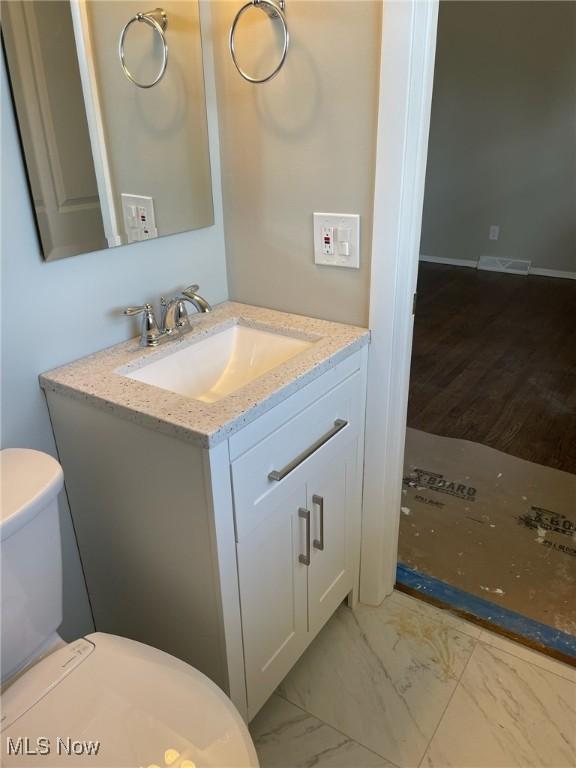 bathroom with visible vents, marble finish floor, vanity, and toilet