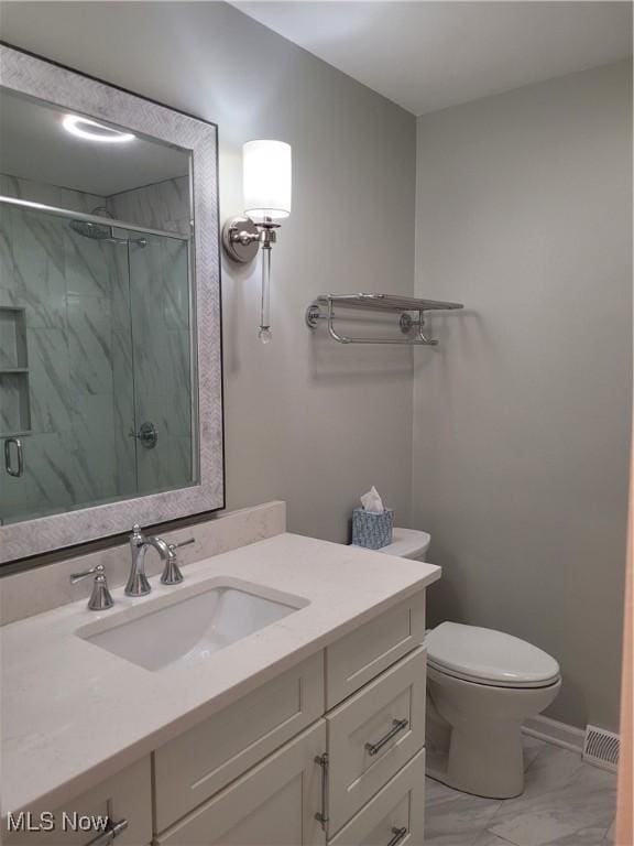 bathroom featuring visible vents, toilet, a stall shower, marble finish floor, and vanity