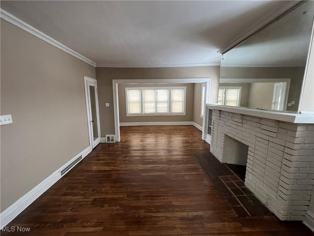 unfurnished living room with dark wood-style floors, crown molding, and baseboards