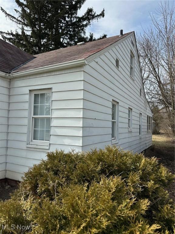 view of home's exterior featuring a shingled roof