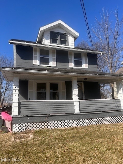 view of front of house with a porch and a front yard