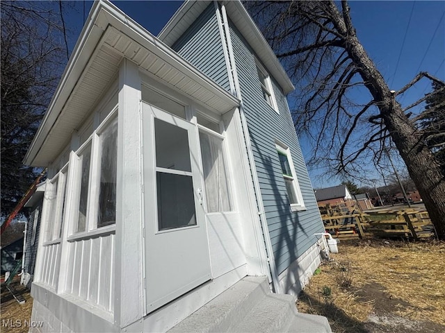 view of home's exterior with a sunroom