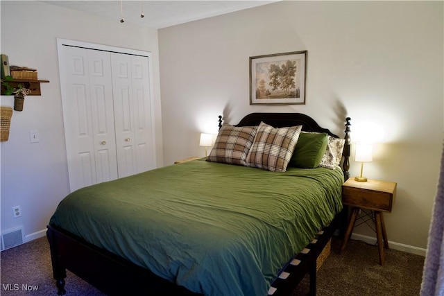 bedroom with a closet, visible vents, baseboards, and carpet