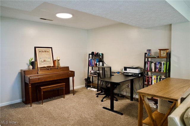 office featuring carpet, visible vents, and baseboards