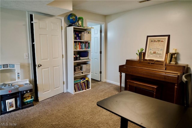 living area with visible vents, baseboards, and carpet