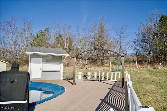 view of pool with a yard and an outdoor structure