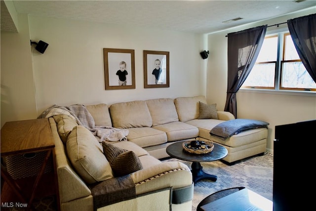 living room featuring visible vents and a textured ceiling