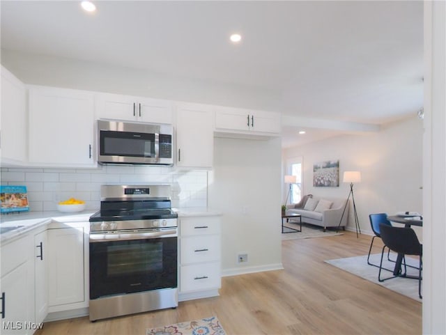 kitchen with white cabinetry, tasteful backsplash, appliances with stainless steel finishes, and light countertops