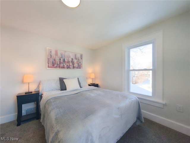 bedroom with baseboards and carpet floors