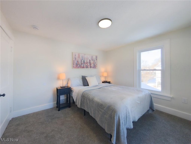 bedroom with baseboards and carpet floors