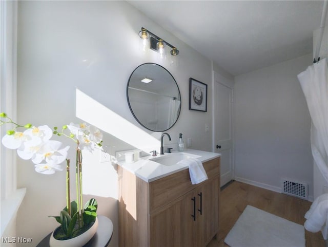 bathroom featuring vanity, wood finished floors, and visible vents