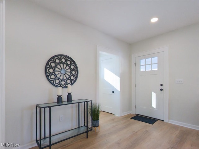 foyer with recessed lighting, baseboards, and wood finished floors