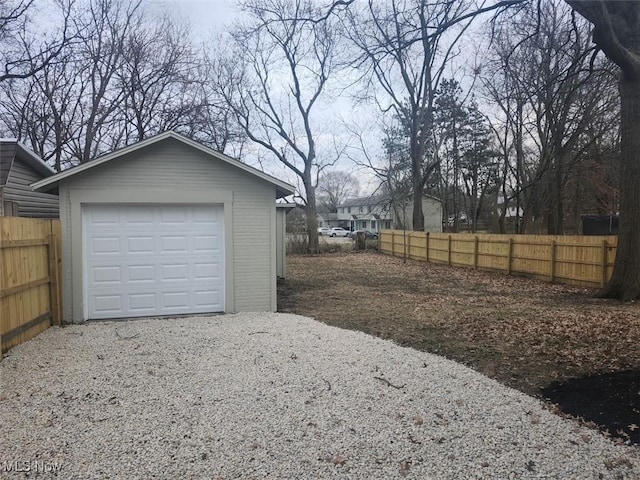 detached garage with fence and driveway