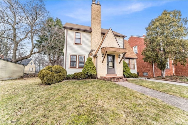 view of front of property with a front yard and a chimney