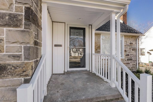 property entrance with stone siding