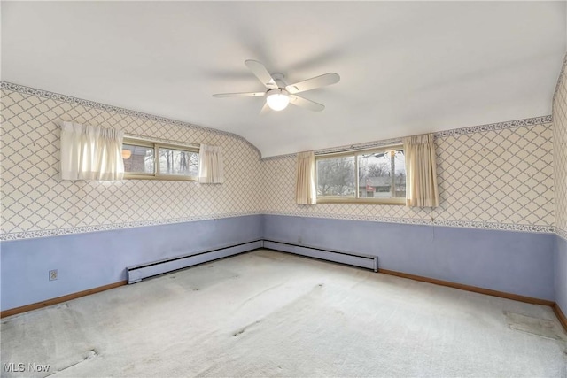 carpeted empty room with wallpapered walls, a ceiling fan, lofted ceiling, and baseboards