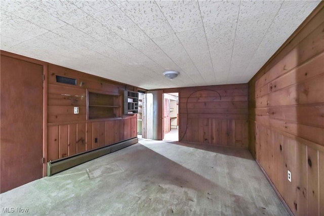 interior space with wooden walls and a baseboard radiator