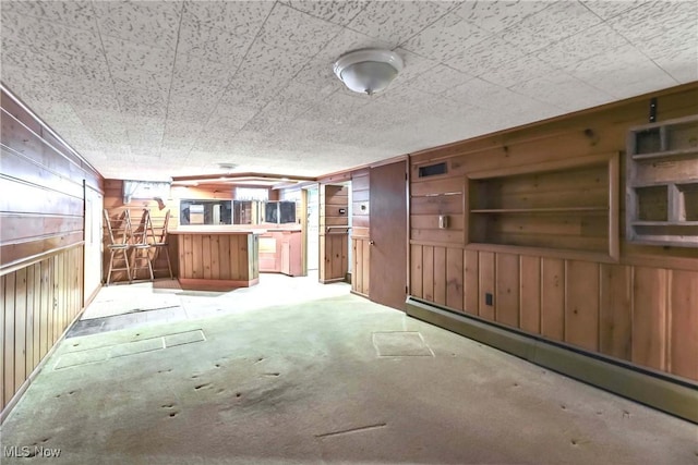 kitchen with visible vents, wood walls, and carpet