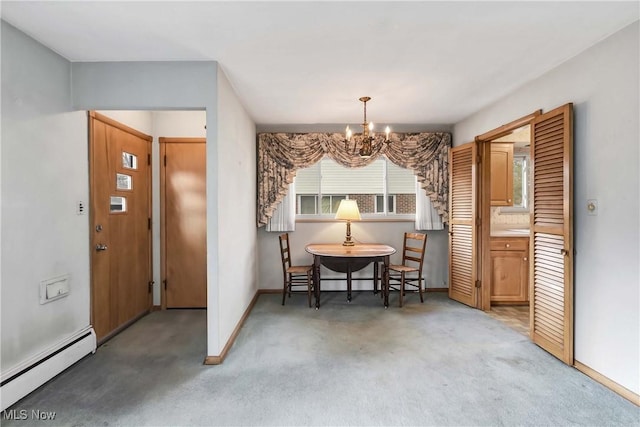 dining room with a baseboard heating unit, light carpet, baseboards, and a chandelier