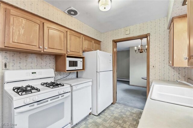 kitchen featuring visible vents, a sink, a baseboard heating unit, white appliances, and wallpapered walls