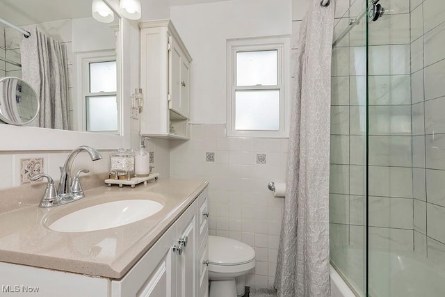 4707 Brookhigh Dr, Brooklyn, OH 44144 - bathroom with shower / bathtub combination with curtain, vanity, tile walls, and toilet