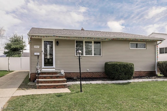 4707 Brookhigh Dr, Brooklyn, OH 44144 - view of front of house with a front yard, entry steps, fence, and a shingled roof