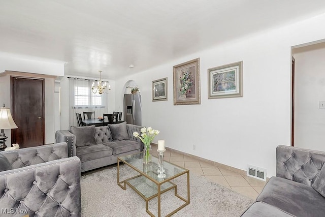 4707 Brookhigh Dr, Brooklyn, OH 44144 - living area with light tile patterned floors, arched walkways, visible vents, a chandelier, and baseboards
