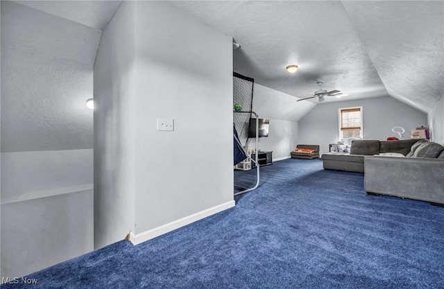 living room with carpet, baseboards, lofted ceiling, ceiling fan, and a textured ceiling