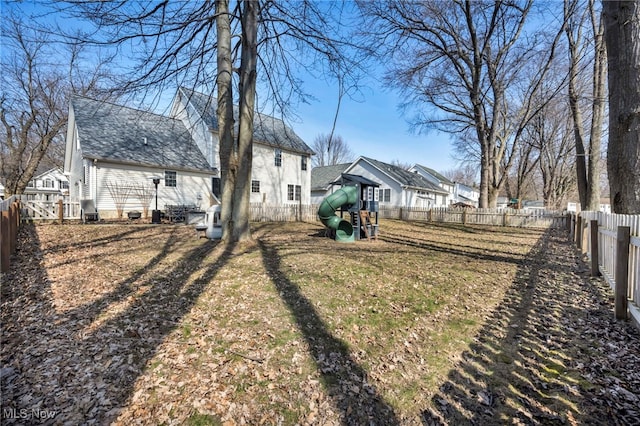 view of yard featuring a fenced backyard and a playground