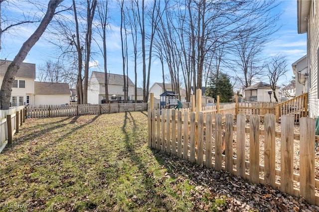 view of yard featuring a residential view and a fenced backyard