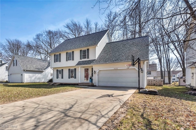 view of front of house with an attached garage, a shingled roof, driveway, and a front lawn