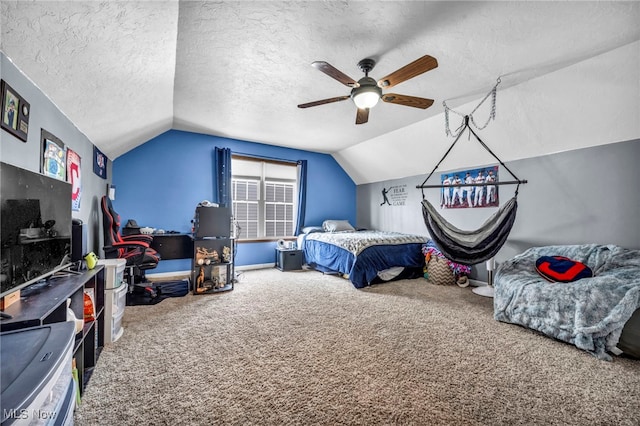 bedroom featuring carpet flooring, ceiling fan, a textured ceiling, and lofted ceiling